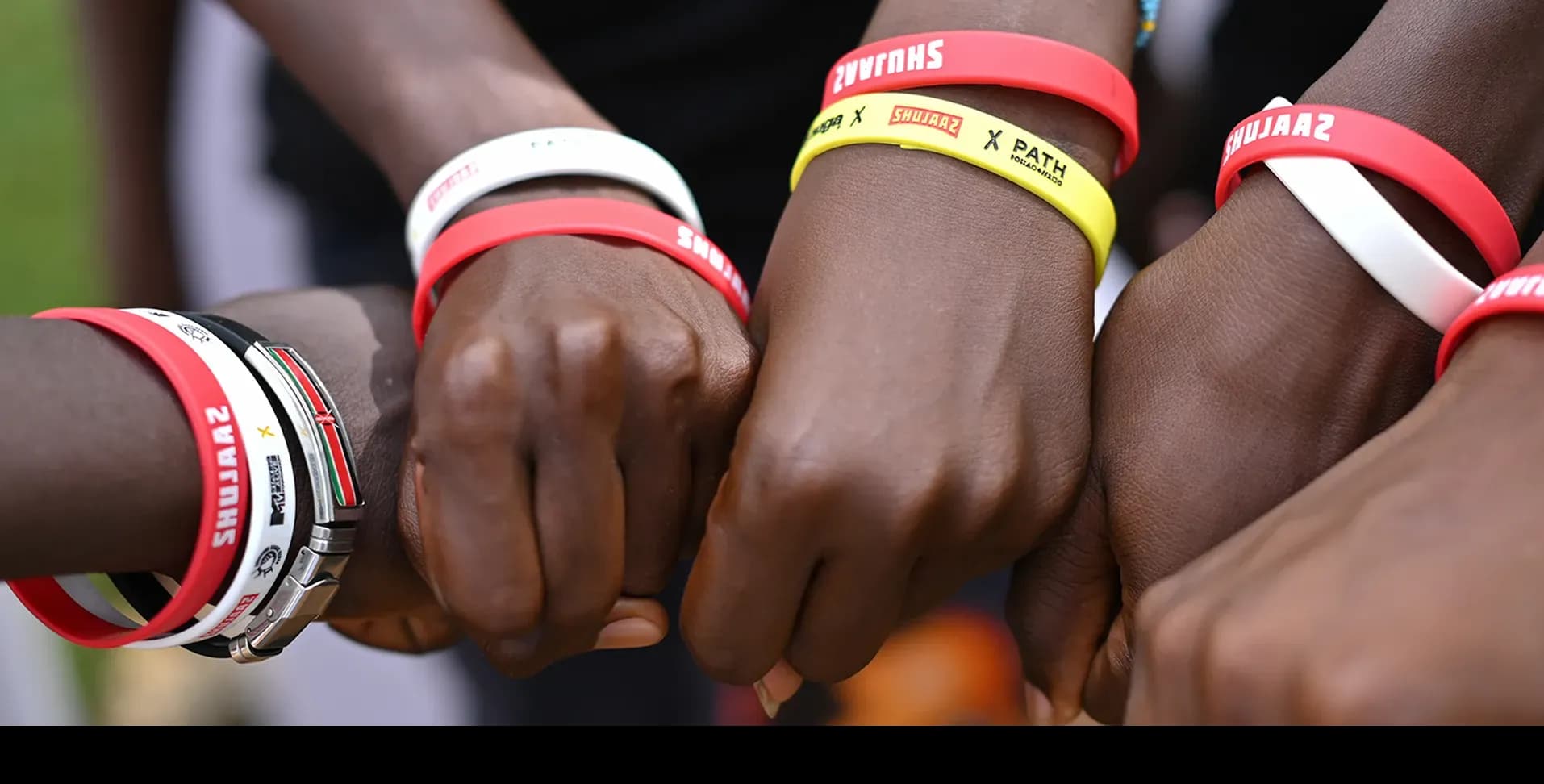 A diverse team joining hands to celebrate a partnership