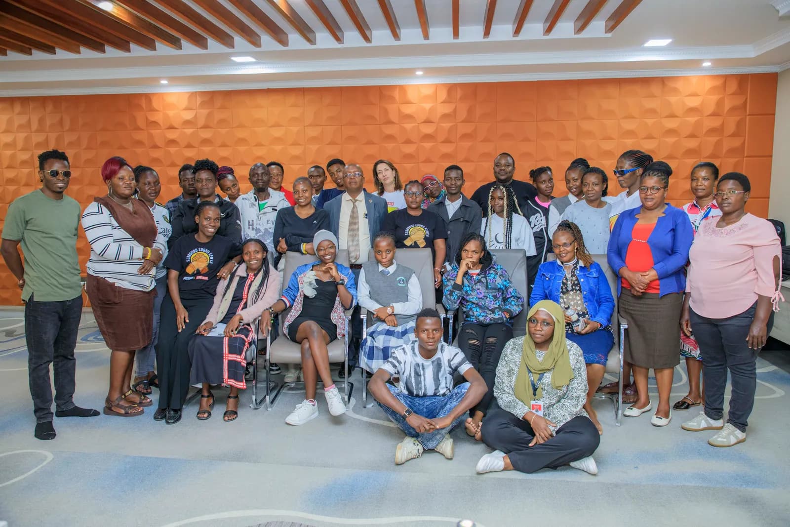 A large group portrait of young people and facilitators at a Surround Sound Kenya gathering